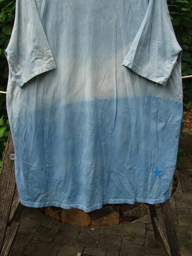 Barclay Tournesol Tunic Flower Power Mottled Day Sky OSFA, featuring a loose fit, drop shoulders, and three-quarter sleeves, showcasing a unique star pattern and rounded neckline in organic cotton.