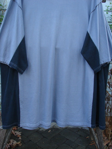 Barclay Cotton Interlock Contrast Side Panel Tunic Scenic Travel Sky Black Size 2 displayed on a rack, showcasing its three-quarter wide sleeves, wide neckline, and contrasting side panels, highlighting its unique design elements.