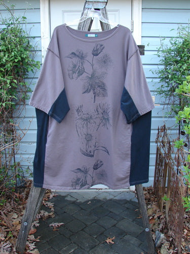 Barclay Cotton Interlock Contrast Side Panel Tunic Floral Plum Black Size 2 displayed on a hanger, showcasing three-quarter sleeves, boatneck, and floral design on plush fabric with contrasting side panels.