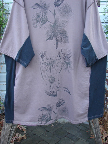 Barclay Cotton Interlock Contrast Side Panel Tunic Floral Plum Black Size 2, features three-quarter wide sleeves, slightly belled A-line shape, contrasting side panels, and a contour floral theme, embodying Blue Fish's vintage aesthetic.