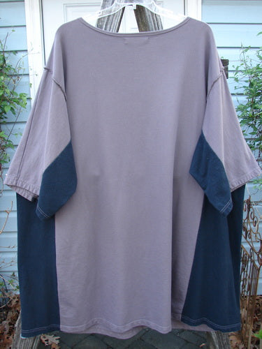 Barclay Cotton Interlock Contrast Side Panel Tunic Floral Plum Black Size 2 displayed on a hanger, showcasing its wide sleeves, boatneck neckline, slightly belled A-line shape, and contrasting side panels.