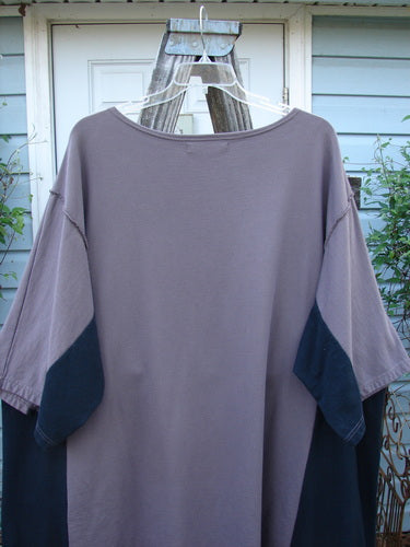 Barclay Cotton Interlock Contrast Side Panel Tunic Floral Plum Black Size 2 on a hanger, showcasing its wide sleeves, boatneck neckline, belled A-line shape, and contrasting side panels.