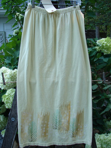 2000 Straight Skirt Pine Forest Plantain Size 1 hanging on a clothesline, showcasing a full elastic waistband and a slight A-line shape with a blue pine forest design along the hem.