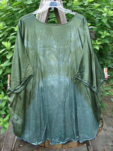 Barclay Viscose Vitreous High Low Tunic Botanicals Mottled Forest Sun OSFA, showcasing a rounded neckline, varying hem, vented sides, and exterior stitchery, hangs gracefully, embodying BlueFishFinder's unique vintage style.