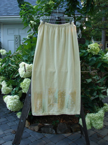 2000 Straight Skirt Pine Forest Plantain Size 1 hanging on a rack, showcasing its full elastic waistband and slight A-line shape, with a detailed pine forest theme along the hem.