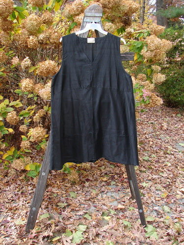 2000 Shaunting Silk Layering Jumper Unpainted Black Size 2 displayed on a wooden stand, featuring an A-line shape, deep V neckline, sectional panels, and drop rear waistline.