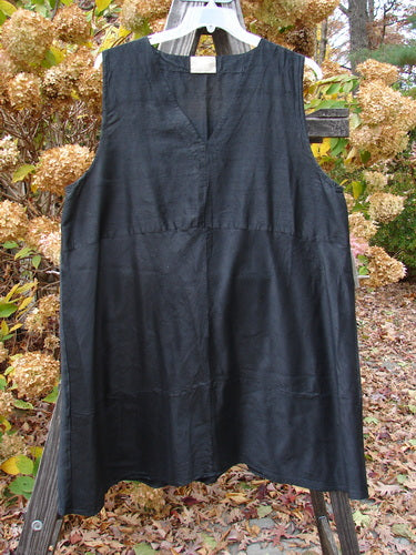 2000 Shaunting Silk Layering Jumper Unpainted Black Size 2 draped over a fence, showcasing its A-line shape, deep V neckline, and unique sectional panels.