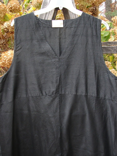 2000 Shaunting Silk Layering Jumper Unpainted Black Size 2 displayed on a clothes hanger, featuring an A-lined shape, deep V neckline, and sectional panels.