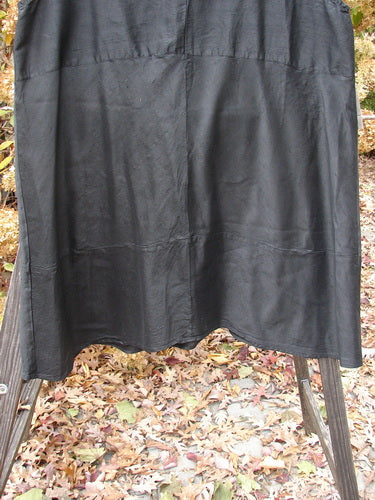 2000 Shaunting Silk Layering Jumper Unpainted Black Size 2 hanging on a clothesline, showcasing its A-lined shape, deep V neckline, and unique sectional panels.
