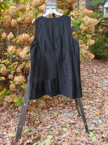 2000 Shaunting Silk Layering Jumper Unpainted Black Size 2 on a wooden stand, featuring a deep V neckline, A-line shape, and unique sectional panels.