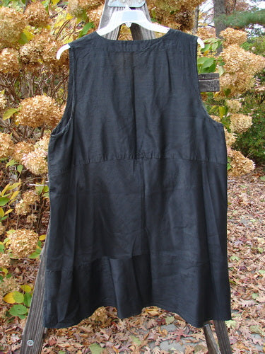 2000 Shaunting Silk Layering Jumper in Unpainted Black, Size 2, displayed on a wooden fence. Features include unique sectional panels, deep V neckline, drop rear waistline, and A-lined shape.