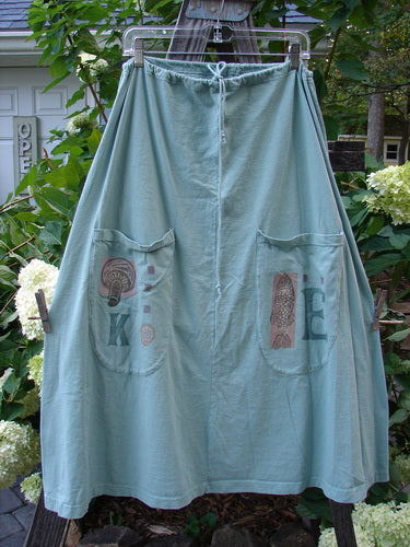 1994 Scoop Pocket Skirt Garden Fish Aloe Size 1, featuring a full drawstring waist, scooped painted pockets, sectional panels, and a sweeping A-line shape, with vintage garden fish theme paint.