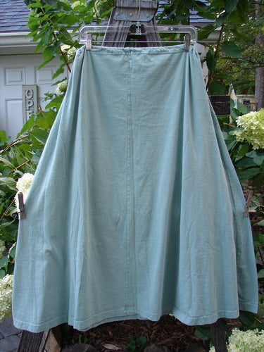 1994 Scoop Pocket Skirt Garden Fish Aloe Size 1 hanging on a clothesline. Features include a drawstring waist, painted scooped pockets, and sweeping A-line shape with a vintage garden fish theme.