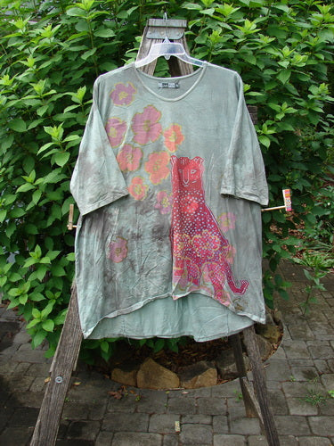 Barclay Tournesol Tunic Spotted Cat Mottled Grass Field OSFA features a loose fit with drop shoulders, three-quarter sleeves, and a longer back hem, showcasing a unique garden and cat motif.