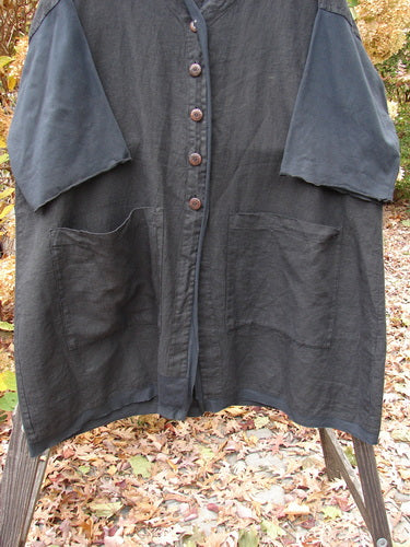 Barclay Cotton Sleeve Pocket Cardigan Unpainted Black Size 2, featuring wooden-like buttons, upward curved hemline, V-shaped neckline, drop shoulders, curly lower sleeves, and front squared-off pockets.