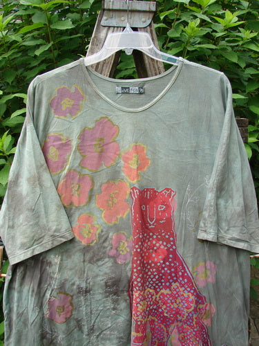 Barclay Tournesol Tunic Spotted Cat Mottled Grass Field OSFA features pink floral patterns and spotted cat theme, showcasing drop shoulders, three-quarter sleeves, and a varying hemline, crafted from organic cotton.
