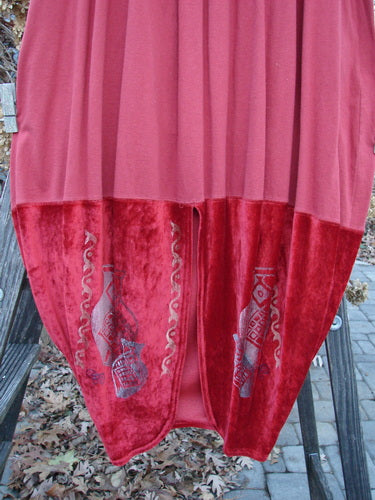 1996 Velvet Arrowhead Sofia Duo Pomegranate Size 1: A red and pink skirt with a red and white design, paired with a matching pullover. Made from stretch velvet and cotton jersey. Features include a V neckline, velvet accents, drop waistline, and a longer straight shape. Perfect for holiday favorites and everyday wear.
