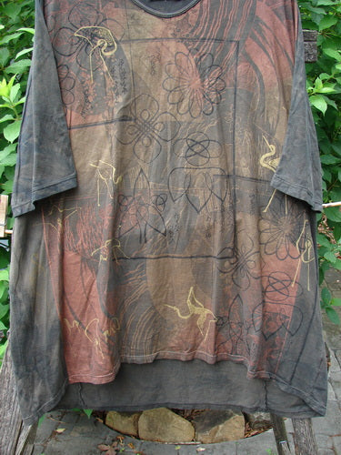 Barclay Tournesol Tunic Daisy Crane Metallic Bark OSFA displayed on a clothes rack, showcasing its loose three-quarter sleeves, rounded neckline, and varying hemline. The tunic features a distinctive Daisy Crane theme.