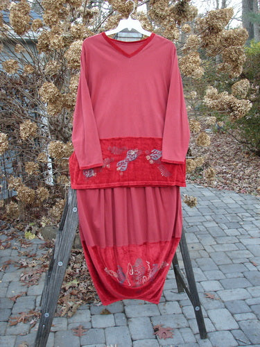 1996 Velvet Arrowhead and Sofia Duo Pomegranate Size 1 displayed on a rack, showcasing the pullover’s velvet-accented V neckline and the skirt’s bell shape with a pegged lower hem.