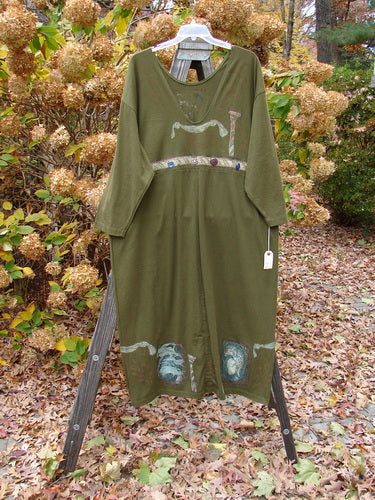 1993 NWT Holiday Button Maker's Dress Roman Goddess Olive OSFA displayed on a wooden rack, showcasing its deep V neckline, vintage buttons, and vertical draw cords.