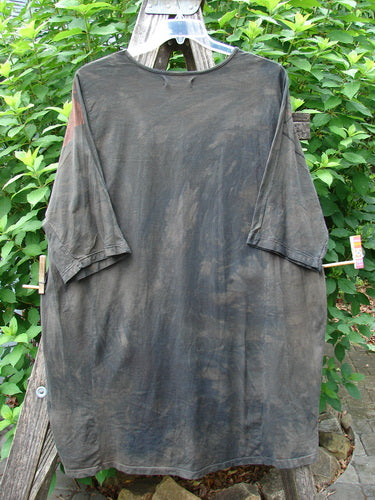 Barclay Tournesol Tunic Daisy Crane Metallic Bark OSFA hanging on a clothesline, showcasing its tunic length, rounded neckline, drop shoulders, and loose three-quarter sleeves with varying hemline.