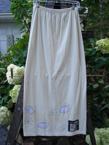 1999 Straight Skirt Fish School Dust Size 0 hanging on a clothesline, showcasing a straighter shape with a full elastic waistband and fish school theme painted around the hem.