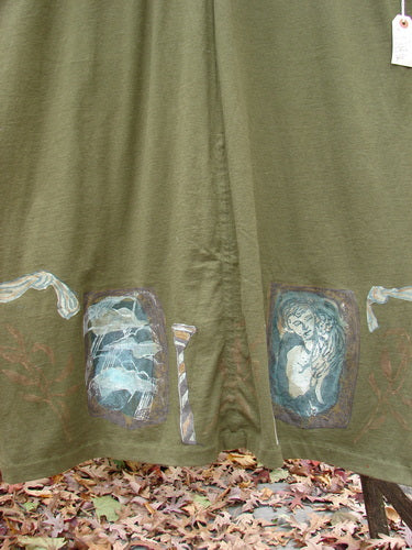 1993 NWT Holiday Button Maker's Dress Roman Goddess Olive OSFA featuring a deep V-neckline, vintage buttons around the waistline, Roman goddess-themed art, and vertical draw cords on the hem.