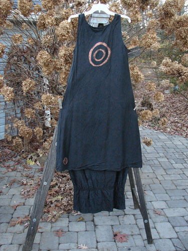 2000 Signed by Jen Shaunting Silk Gather Duo Spin Size 1, featuring a black dress with flowing A-line flair and a matching crushed skirt on a wooden stand.