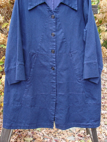 Barclay Denim Triangular Collar Coat Unpainted Royal Size 2 displayed on a swinger, featuring a full button front, banded lower sleeves, diagonal pockets, and unique triangular panels.