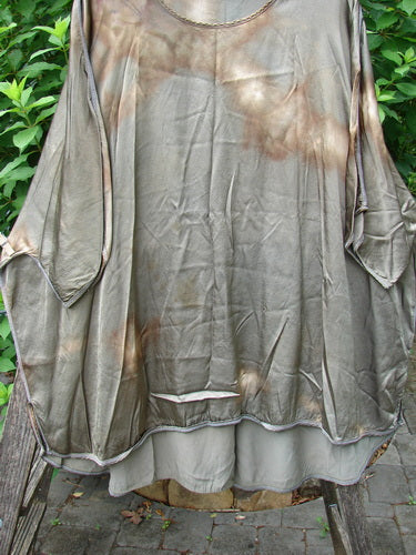Barclay Viscose Vitreous High Low Tunic in Mottled Copper Bronze displayed on an outdoor pole, showcasing its three-quarter dolman sleeves, rounded neckline, and unique varying hem design.