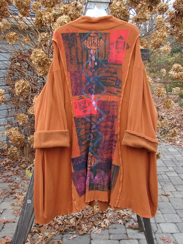 Barclay Thermal Mock Collar Coat Mixed Media Pumpkin Size 2 displayed on a wooden pole, featuring wide sleeves, rolled piping, front pockets, and wooden-textured buttons with a sweeping A-line shape.