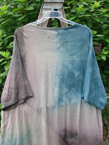 Barclay Art Tee Fern Garden Mottled Pure Dawn OSFA displayed on a swing, featuring a longer tunic length, drop shoulders, loose three-quarter sleeves, and a rounded neckline with a varying hemline.
