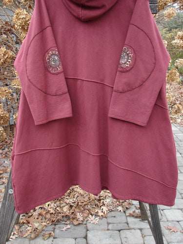 Barclay Patched Interlock Hooded Curve Coat in Red Wine Size 2, featuring a cozy hood, giant circle sleeve patches, and an S-shaped button line with exterior stitchery and deep pockets.