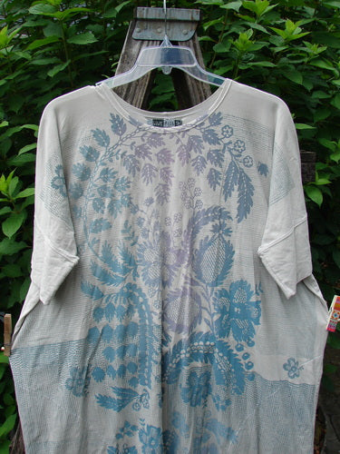 Barclay Long Tee Tie Back Dress in Botanical Garden Rain pattern on a swinger, showcasing its rounded neckline, seamless bodice, and slightly short cuffed dolman sleeves, reflecting Bluefishfinder.com's vintage style.