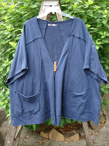 Barclay Photogram Open Front Jacket Rear Daisy Deep Navy OSFA displayed on a wooden pole, highlighting its wide three-quarter sleeves, open front, angular hem, and dolman shoulders in a flowy design.