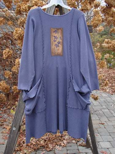 Barclay Patched Thermal Drop Pocket Dress Tiny Leaf Vine Royal Blue Size 1 displayed on an outdoor swing, showcasing its long, floral design and oversized, wrap-around pockets against a natural backdrop.