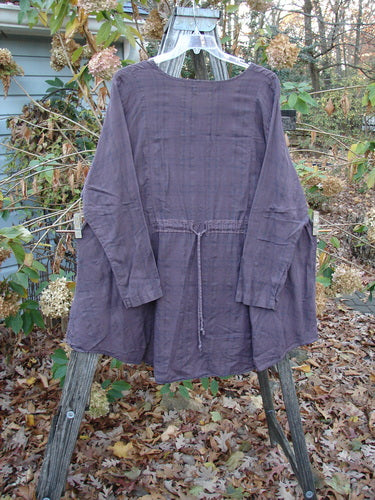 Barclay Draw Back Sectional Pullover Tunic in Forest Garden Wine Stripe, Size 2, displayed on a clothesline. This lightweight, short-sleeved tunic exemplifies BlueFishFinder's vintage style, offering unique, expressive fashion.