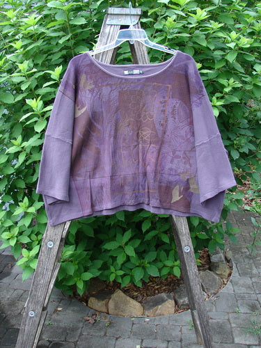 Barclay Thermal Boxy Crop Top Spiro Floral Dusty Plum OSFA with a rounded neckline and three-quarter sleeves, displayed on a wooden ladder, showcasing its unique spirograph floral design and textured thermal fabric.