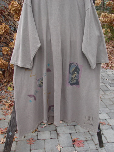 1994 Reprocessed Carriage Coat Ric Rack Raku OSFA featuring a billowy collar, oversized buttons, and deep side pockets, displayed on a clothes rack.