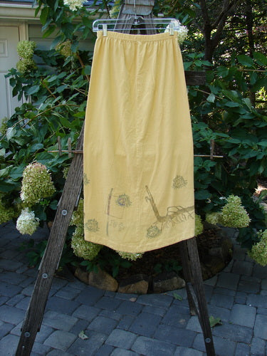 1998 Botanicals Corolla Skirt Digitalis Sundial Size 0 displayed draped on a wooden ladder, highlighting its unique upward curved front and longer rounded back.