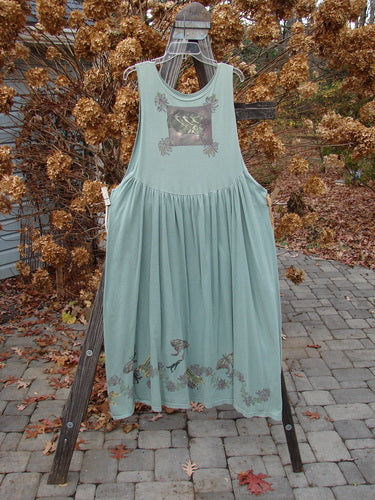 1994 Side Button Jumper Butterfly Garden River Size 1 displayed on a rack, showcasing its rounded neckline, deeper arm openings, and gathered lower fabric with butterfly garden theme paint.