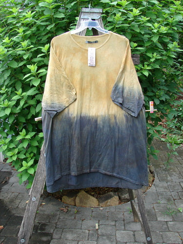 Barclay NWT Art Tee Unpainted Sun Field & Night OSFA displayed on a clothes rack, highlighting its tunic length, drop shoulders, and rounded neckline, embodying Bluefishfinder.com's unique vintage style.