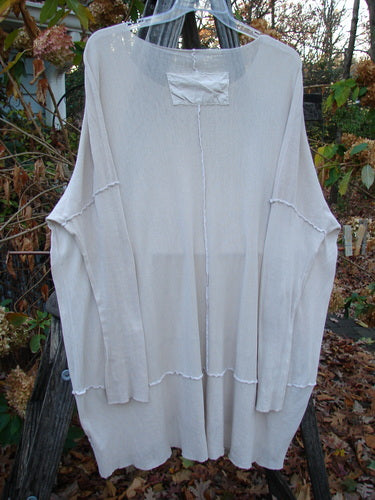 Barclay Cotton Mesh Exterior Stitch Sectional Overtop Unpainted Pink Cloud Size 2 displayed on a clothes rack, showcasing its textured cotton mesh, wide rounded neckline, and long sleeves with exterior stitching.