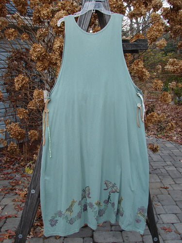 1994 Side Button Jumper Butterfly Garden River Size 1 hanging on a clothesline, showcasing rounded neckline, deeper arm openings, and gathered lower fabric with butterfly garden theme.