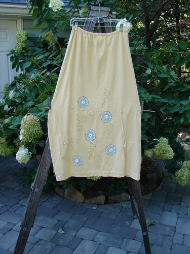 2000 Side Pocket Skirt Pinwheel Plantain Size 0 displayed on a clothes rack, showcasing its full elastic waist, side pocket, and vertical panels with a pinwheel pattern.
