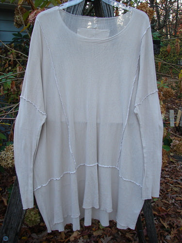 Barclay Cotton Mesh Exterior Stitch Sectional Overtop Unpainted Pink Cloud Size 2 displayed on a clothes rack, featuring long sleeves, rounded neckline, exterior stitching, and drop shoulders.