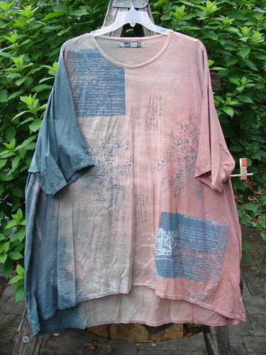 Barclay Art Tee Bicycle Floral Basket Mottled Mauve Gray OSFA features a tunic length, drop shoulders, loose three-quarter sleeves, and a rounded neckline, showcasing a bicycle floral basket design.