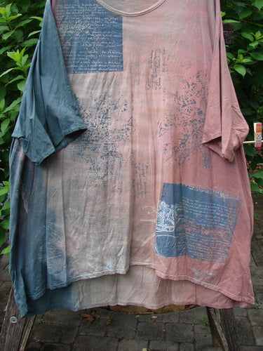 Barclay Art Tee Bicycle Floral Basket Mottled Mauve Gray OSFA features a longer tunic length, drop shoulders, and loose three-quarter sleeves, showcasing a bicycle floral basket theme in organic cotton.