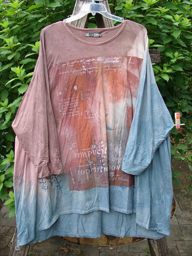 Barclay Art Tee Da Vinci Moon Mottled River OSFA displayed outdoors, draped on a tree, showcasing its tunic length, loose three-quarter sleeves, and unique hemline with artistic design details.