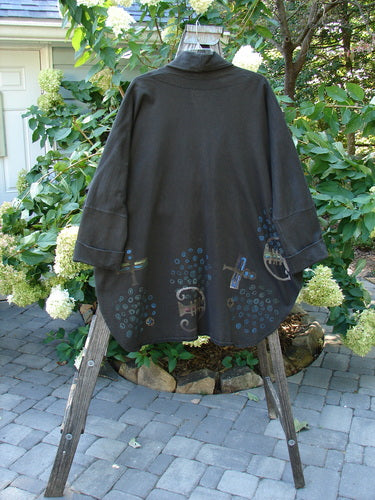 1996 Reprocessed Phoenician Jacket Abstract Travel Obsidian OSFA displayed on a stand, featuring dolman sleeves, deep V neckline, and oversized pockets.